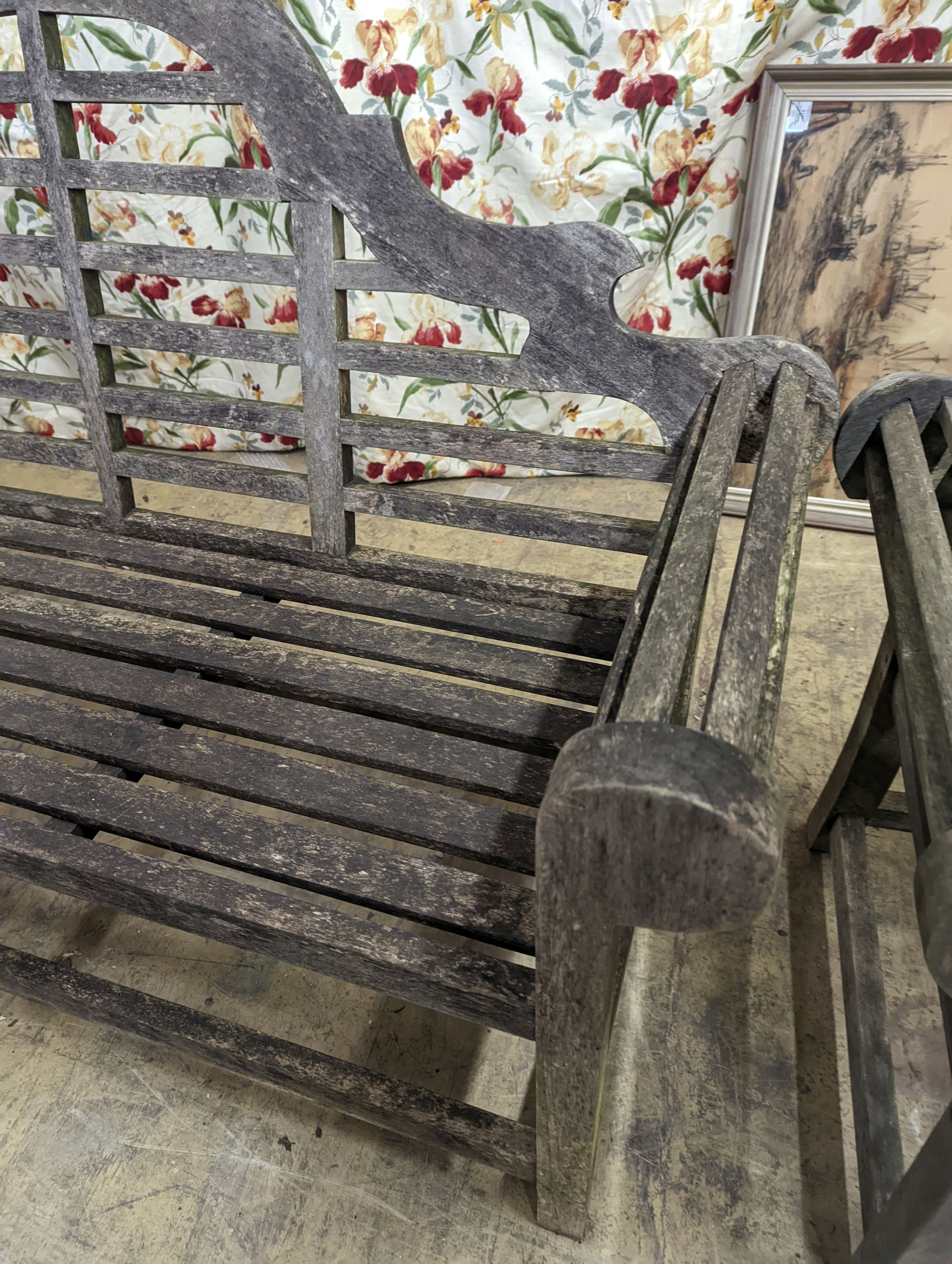 A pair of Lutyens style weathered teak garden benches, length 166cm, depth 53cm, height 105cm